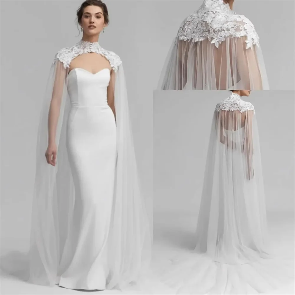 Customized long lace tulle bridal cape with high neck buttons. Lightweight sheer fabric creates stunning aesthetics. Available i