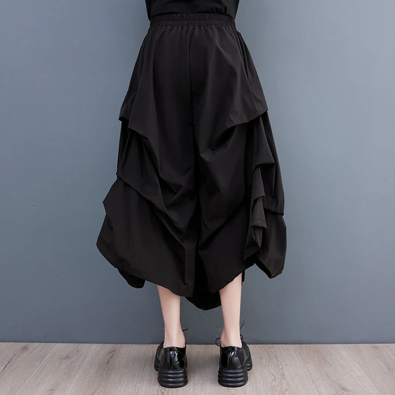 Szerokie spodnie z szerokimi nogawkami, elastyczna talia, plisowana spódnica codzienna, modna, uniwersalna, dobra jakość, możliwość warstwowego noszenia, styl do pracy.