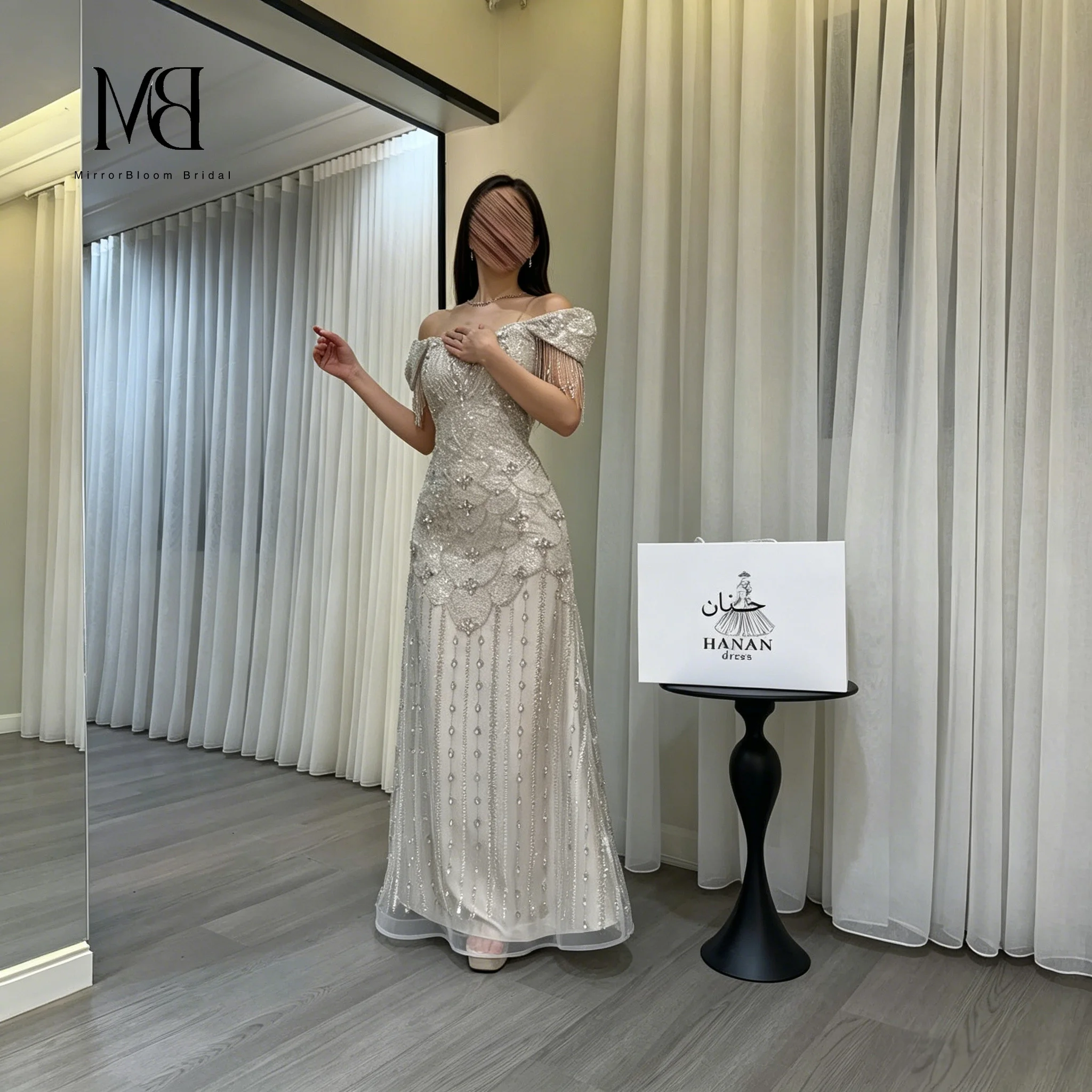 Silver off-the-shoulder strapless sleeveless floor-length mermaid formal gown featuring beaded fringe detailing