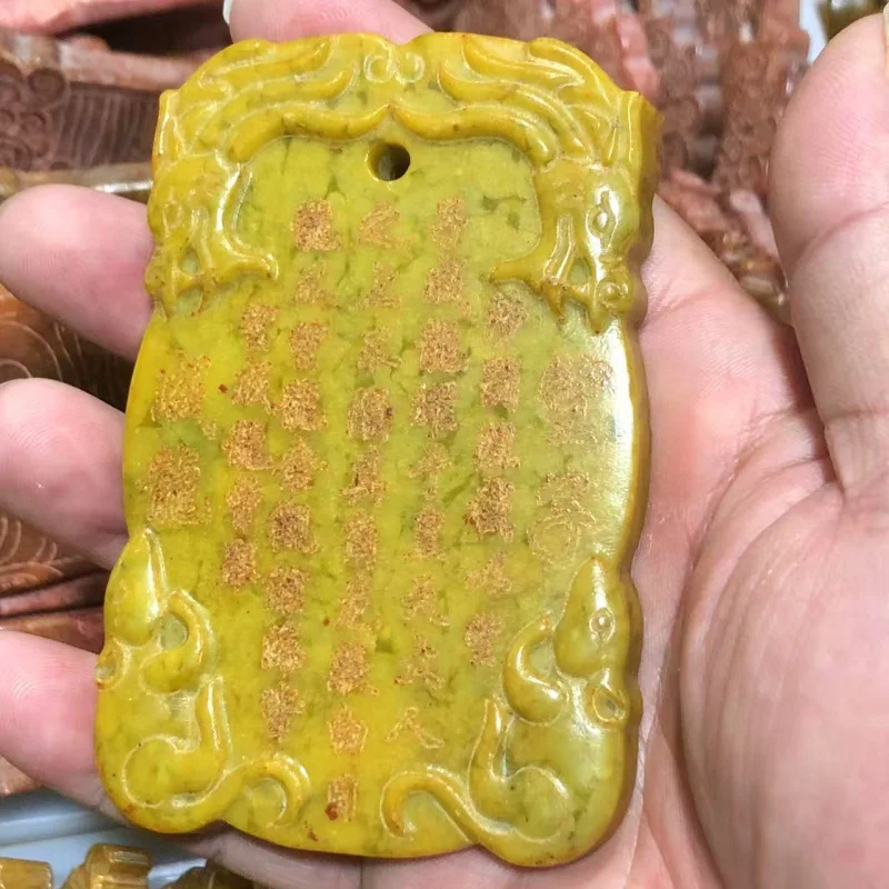 Traditional carving of old Xiu jade pendant with inscription May your children achieve success.