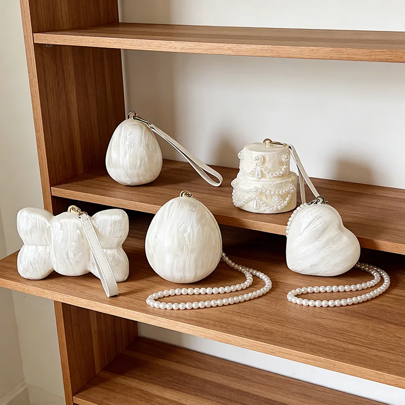 

Уникальный дизайн, женская акриловая ракушка, жемчужная вечерняя сумка, модная сумка-клатч с бантом и жемчугом, дизайн торта с каплей воды, роскошная сумка на плечо