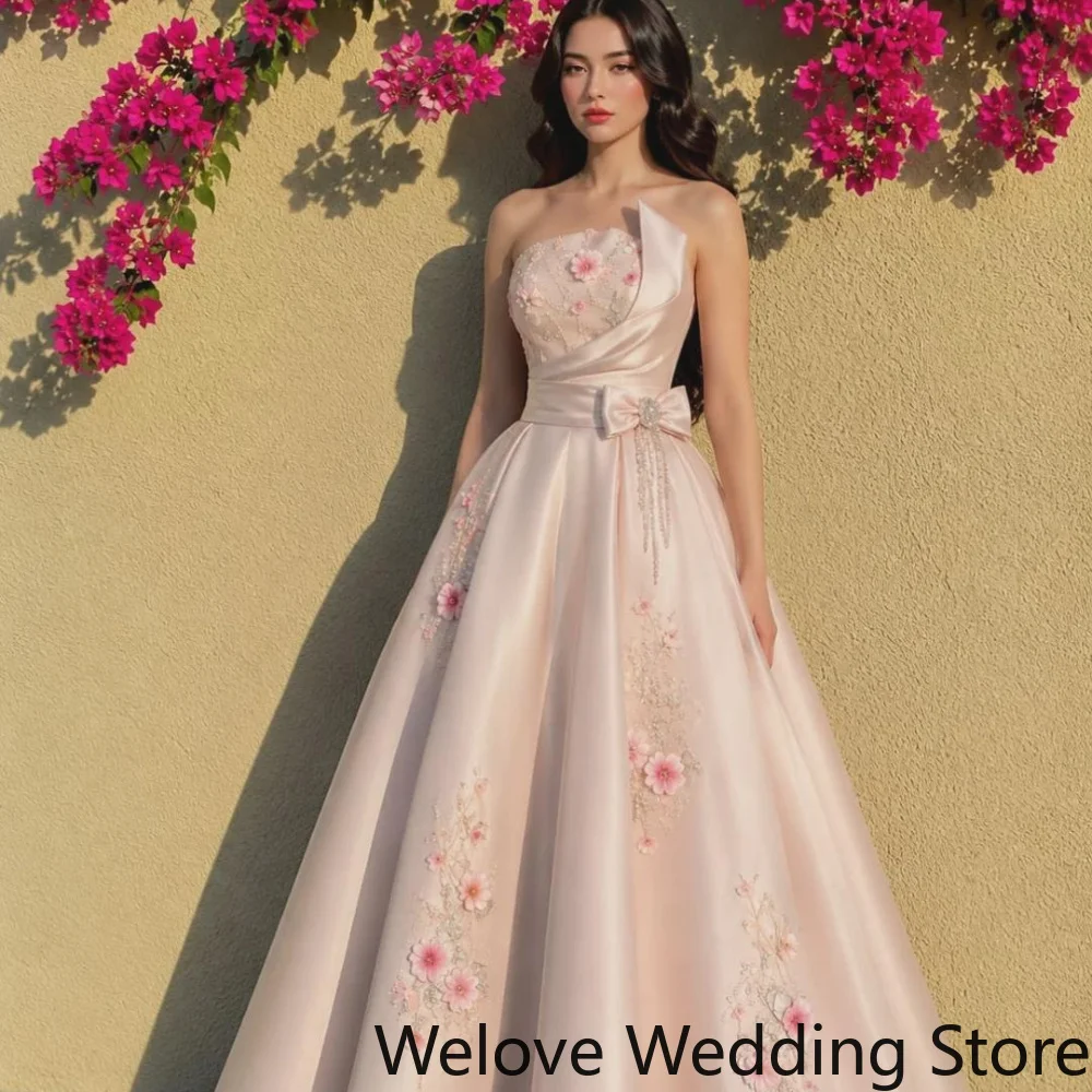 Blush Pink Formal Ball Gown Featuring a Strapless Neckline, Voluminous Satin Skirt, and Delicate 3D Floral Embroidery