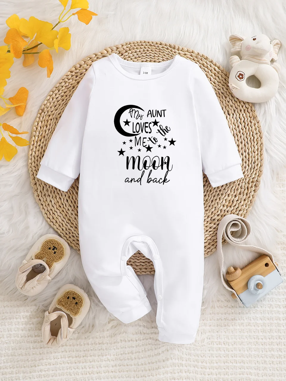 A baby long-sleeved onesie with interesting letter prints. It features a buttoned design for easy putting on and taking off