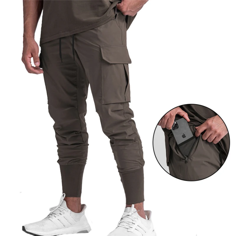 Pantaloni da palestra versatili da uomo ad asciugatura rapida pantaloni sportivi multitasche all\'aperto Fitness Jogging pantaloni lunghi pantaloni