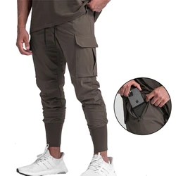 Pantaloni da palestra versatili da uomo ad asciugatura rapida pantaloni sportivi multitasche all'aperto Fitness Jogging pantaloni lunghi pantaloni Cargo da allenamento sportivo