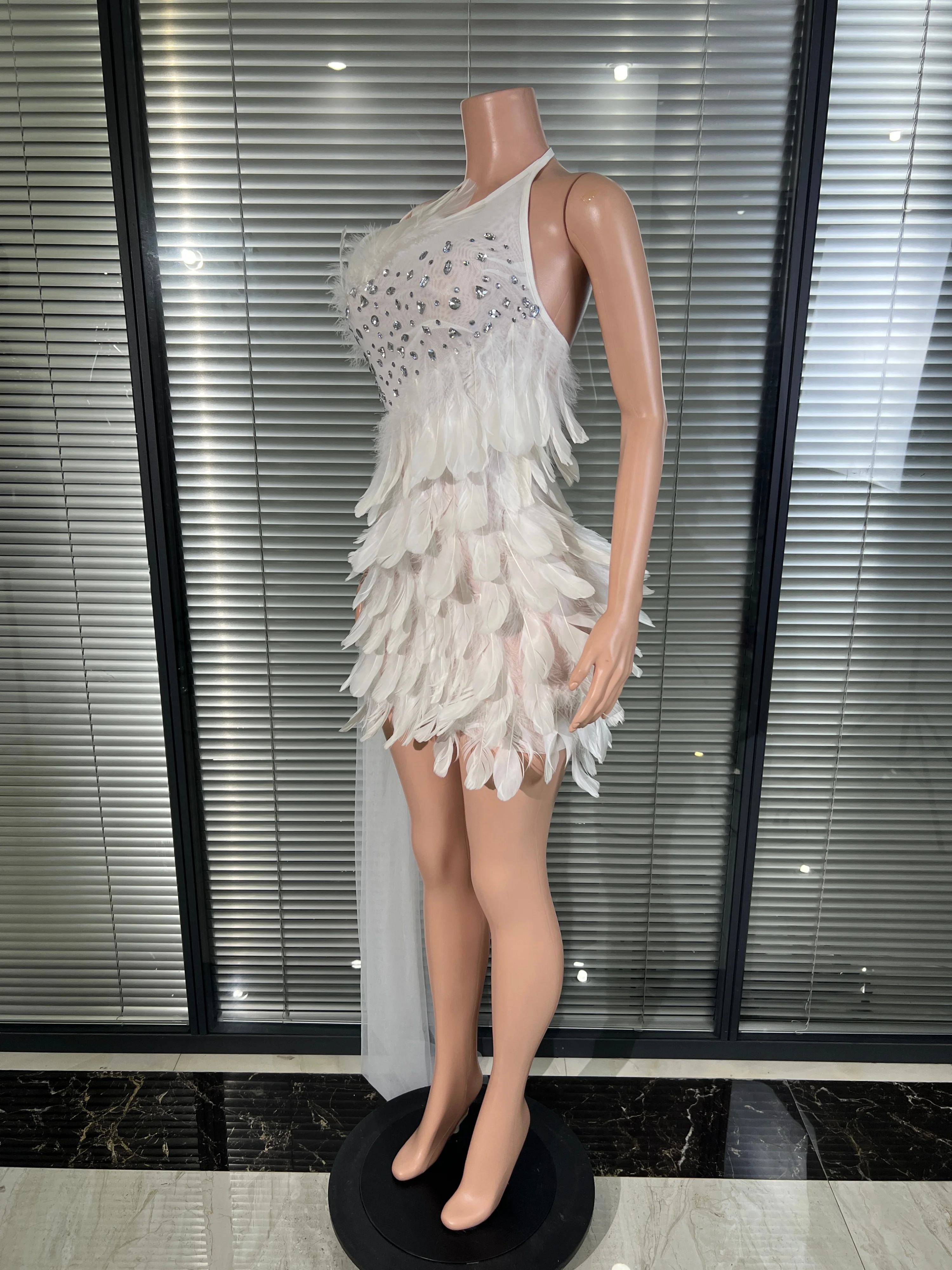White feathered mini dress, decorated with rhinestones, with long pleated trailing hem. Suitable for formal dinners other forma