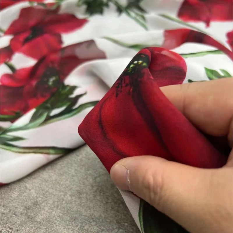 

The new product thin and transparent dress fabric made of georgette silk with white background large red floral prints