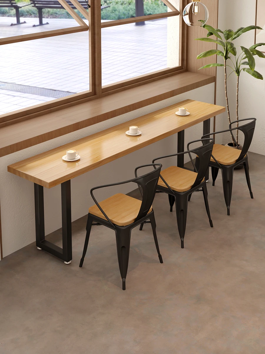

Wrought iron long narrow table fast food restaurant canteen snack bar against wall by the window table noodle res