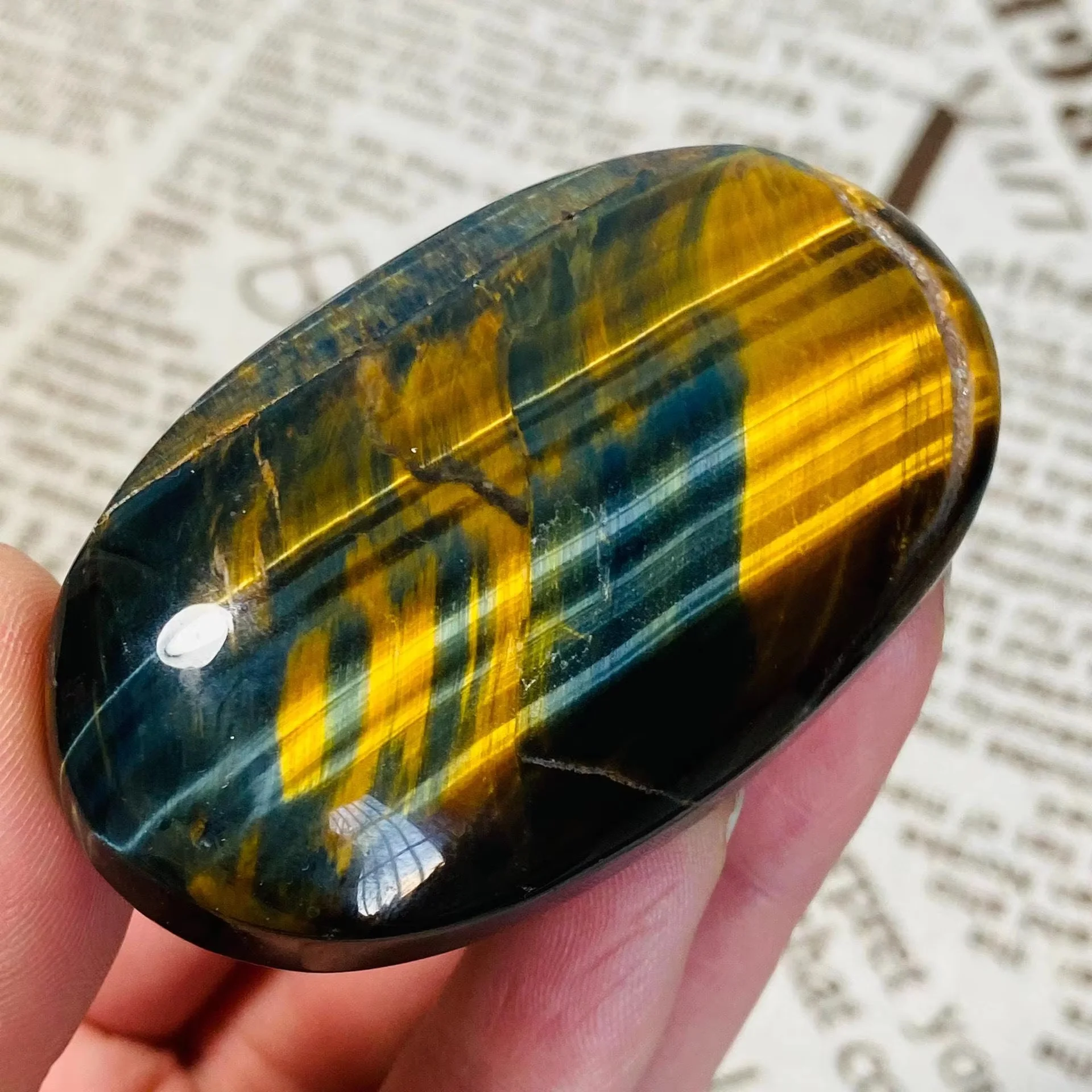 One natural blue tiger's eye palm stone - mirror polished with gold stripes, suitable for Christmas, graduation ceremonies.