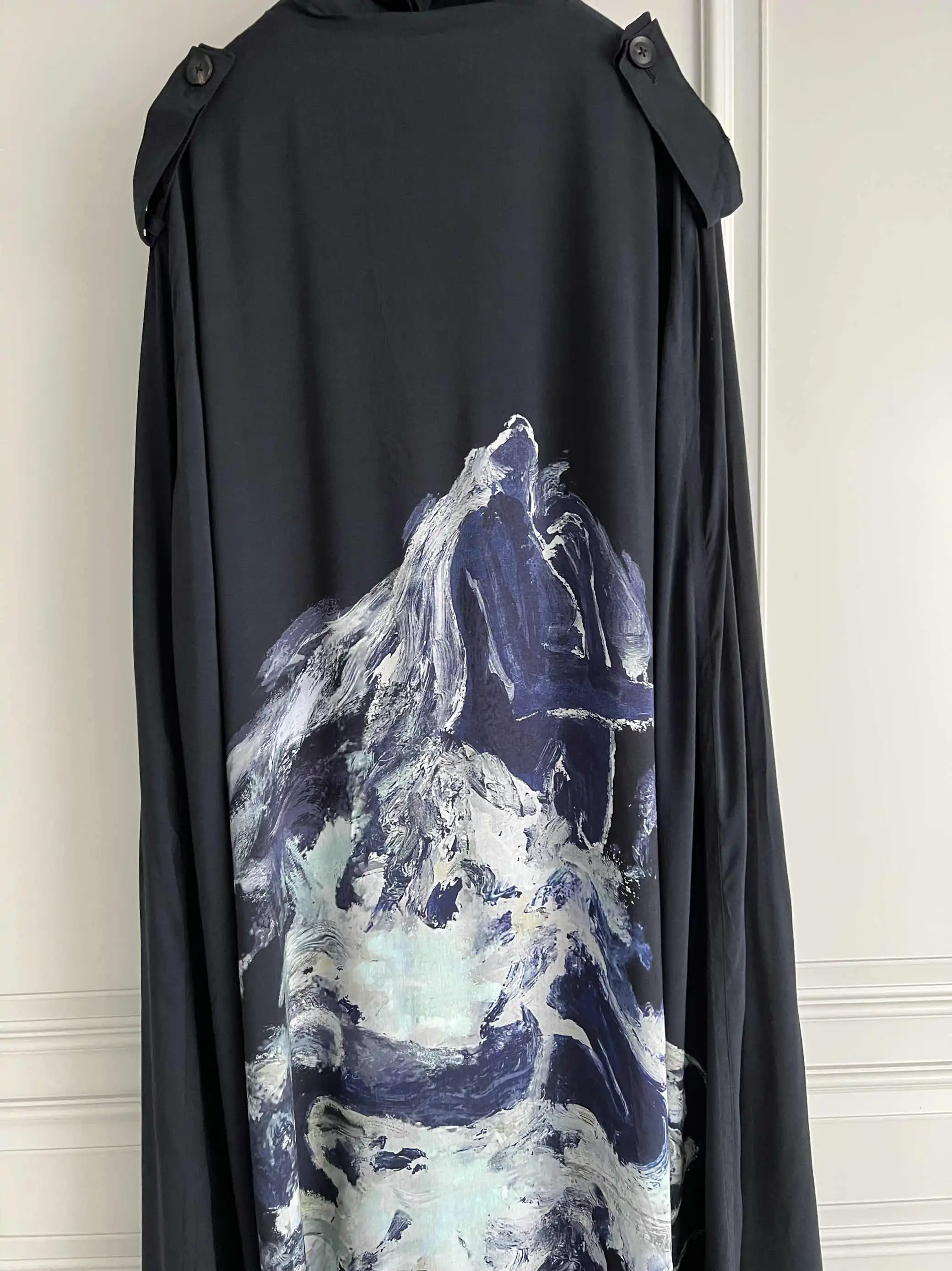 

TOP-YAMAMOTO's original design features a dark style asymmetrical print feel hooded cape-style trench coat that is loose and tre