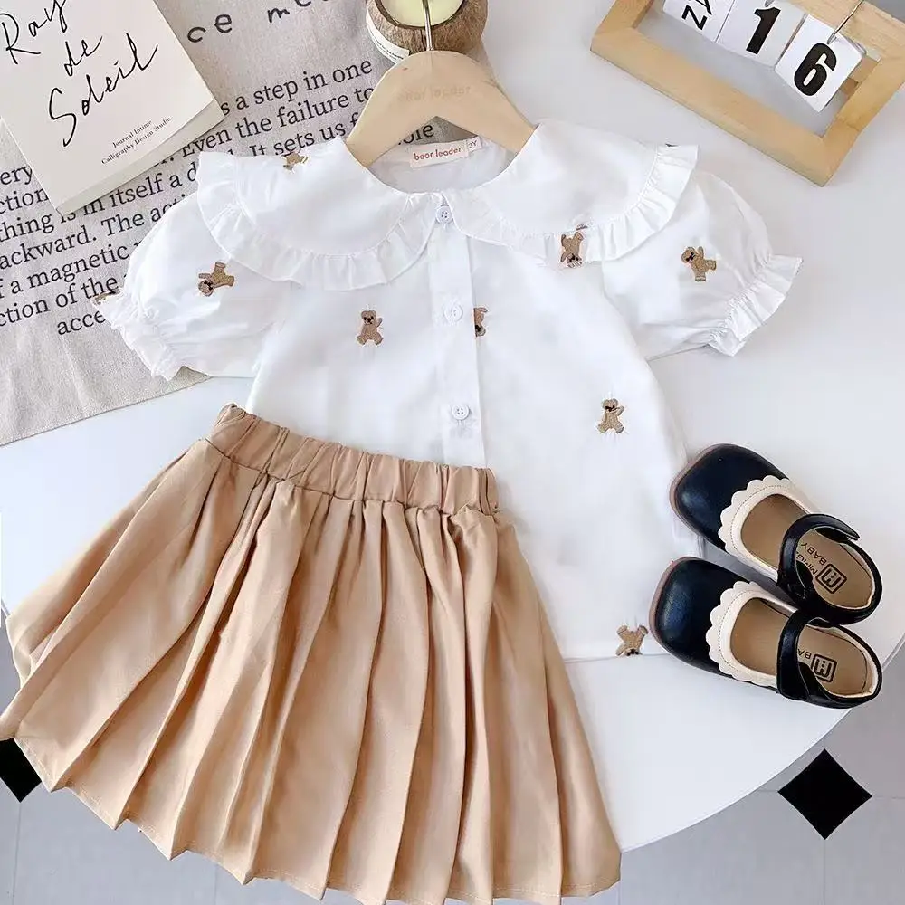 

Girls' Summer Clothes Preppy Style Kids Clothes Girls Cute Cartoon Bear Printed White Shirt + Khaki Pleated Skirt Two-piece Set