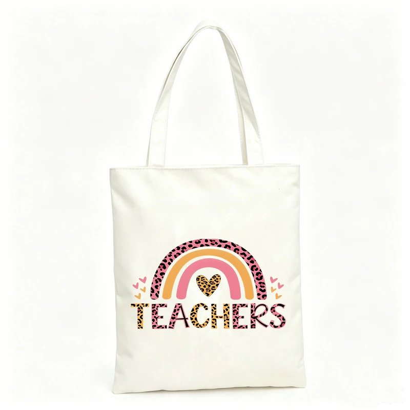 Teacher's canvas tote bag with rainbow and heart pattern, ideal for school use and daily outings