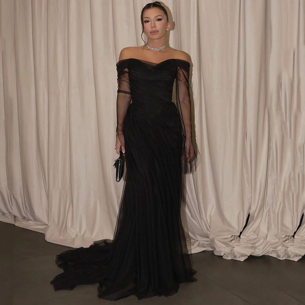 Sukienka wieczorowa z czarnego tiulu z dekoltem w łódkę, z iluzorycznymi, długimi rękawami, trenem zamiatającym, odkrytymi plecami, do ziemi, idealna na studniówkę.