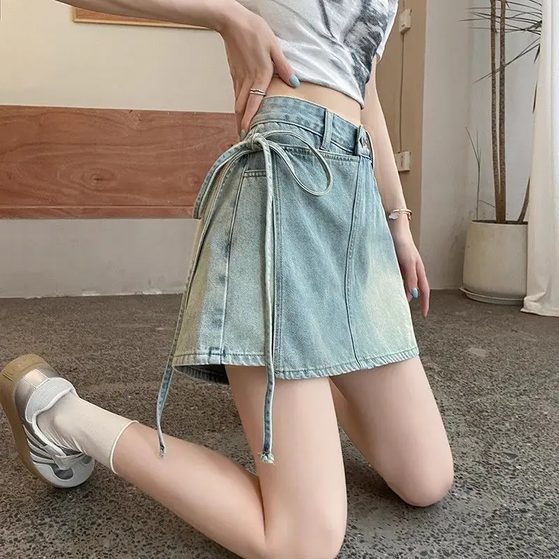 Fake two pieces of denim shorts women\'s summer new A-shaped high waist irregular western-style strap skirt slim Joker hot pants.