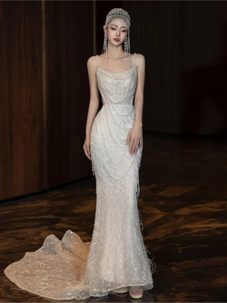 

A niche and light luxury pearl halter dress with slender fish tail to welcome guests