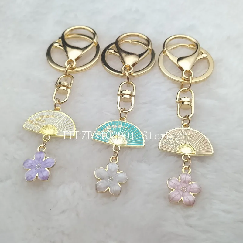 LLavero de flores de cerezo de estilo japonés para madre, bonito llavero con colgante de esmalte, ropa, llavero de colgante