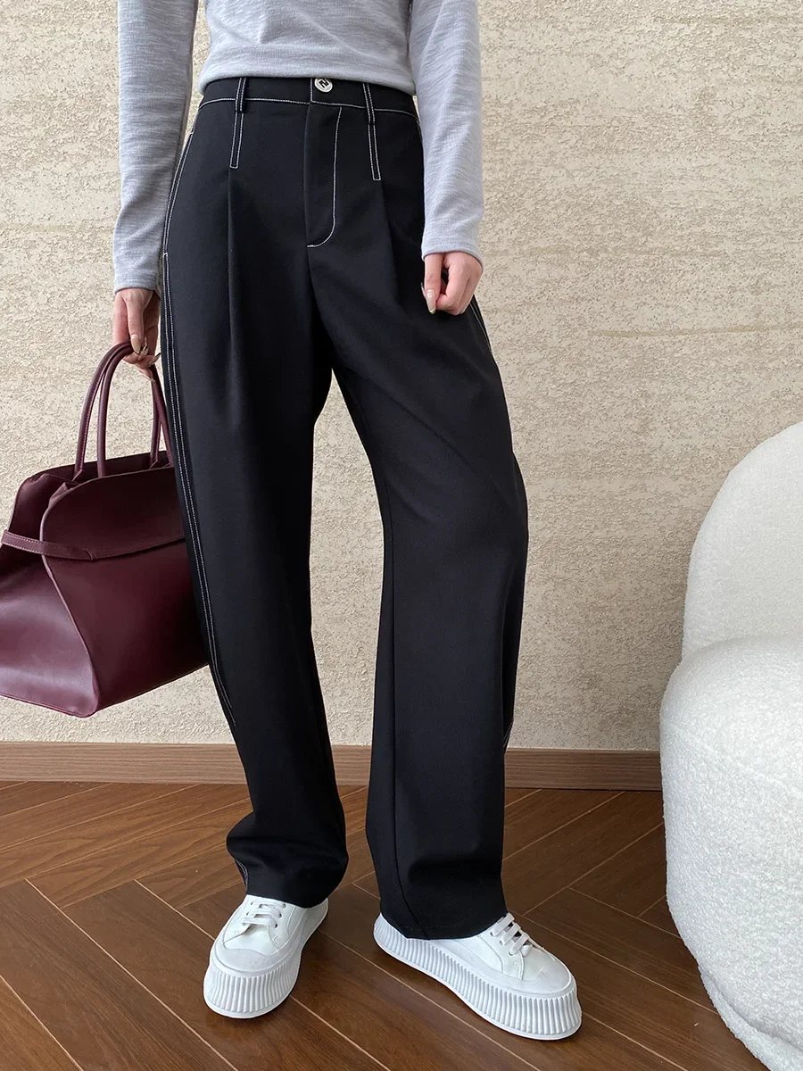 Deconstructed, split exposed outer seams, straight, loose, drapey casual pants with a yuppie vibe.