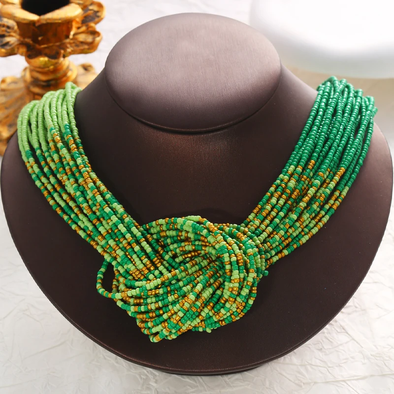 A Bohemian-style necklace featuring fresh green tones, handcrafted with small beads strung together in a woven pattern.