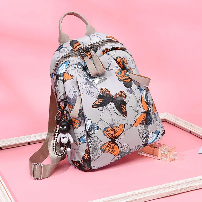 حقيبة ظهر صيفية خفيفة الوزن للنساء على الطراز الكوري مطبوعة على شكل فراشة باتن كاجوال مضادة للسرقة كبيرة