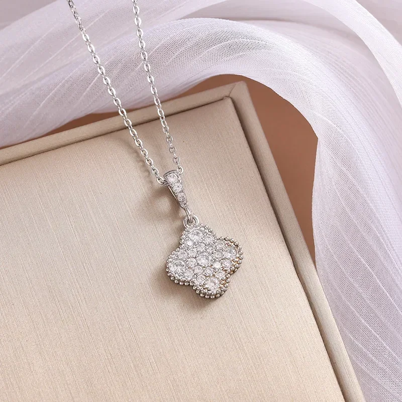 A luxurious, diamond-encrusted copper four-leaf clover with a necklace is live-streaming by a female 9527