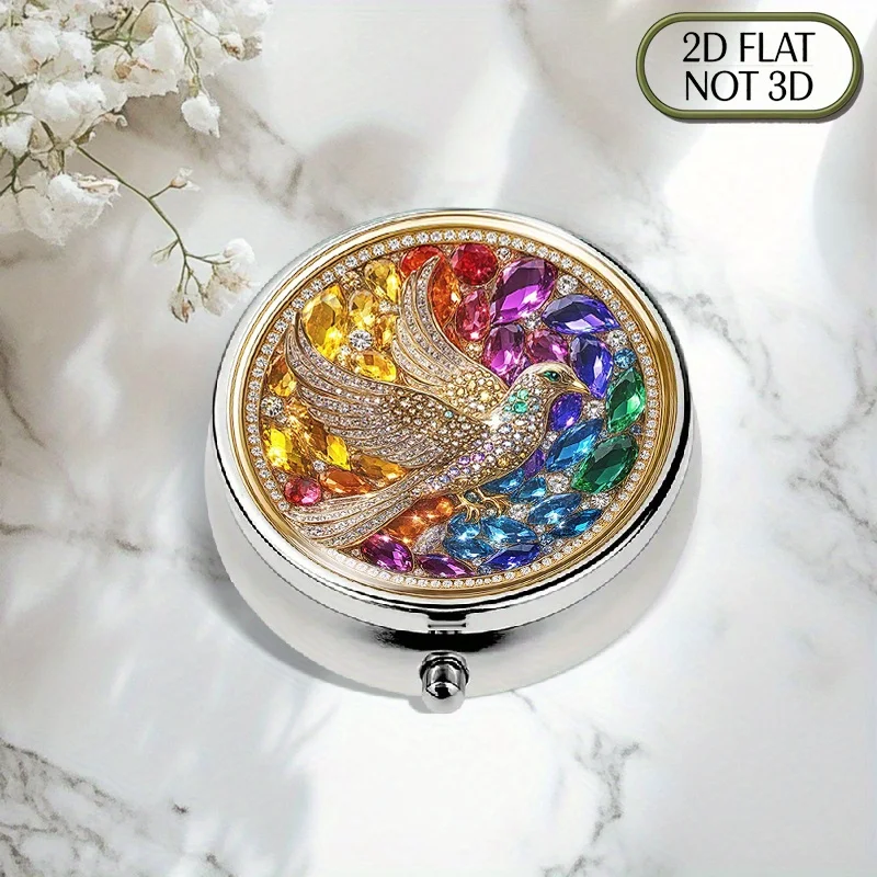 A flat, portable, round, three-compartment metal pill box, featuring a golden frame inlaid with colorful crystal pigeons, adorned with sparkling gemstones and diamonds. It is a stylish pill organizer suitable for organizing medication, storing vitamins, and other multifunctional purposes, with a flat design