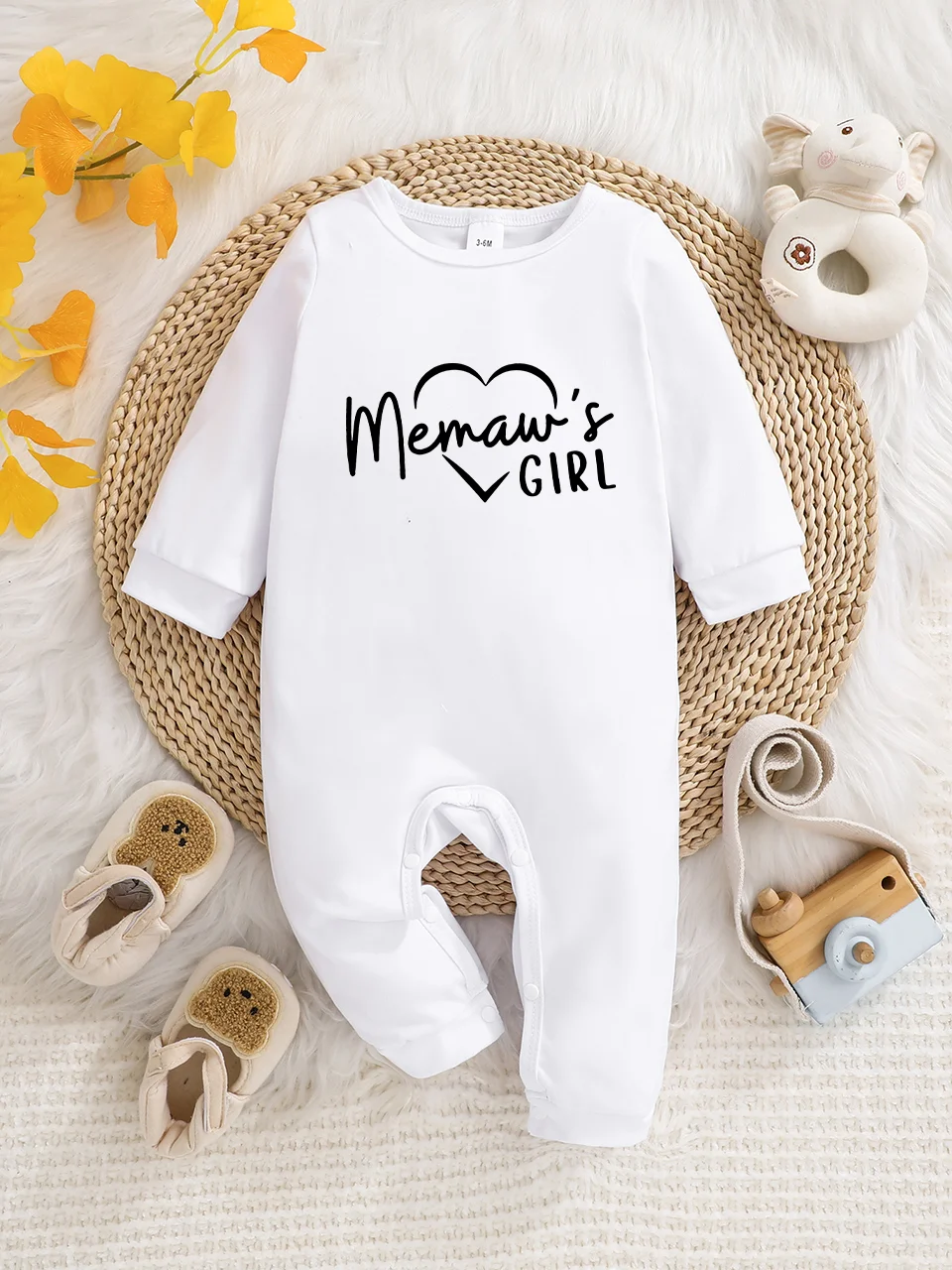 A baby long-sleeved onesie with interesting letter prints. It features a buttoned design for easy putting on and taking off