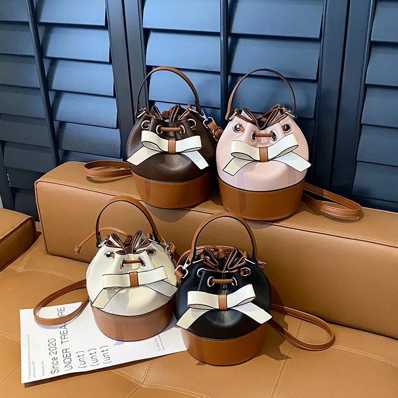 

2026 Fashion Light Luxury Women's Bag Contrast Color Niche Bow Portable Bucket Bag Drawstring Splicing Large Capacity Woman Bag