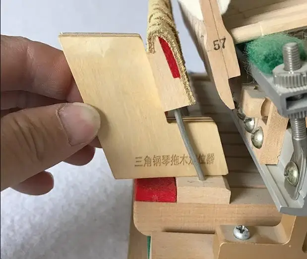 Positioner for grand piano string machine