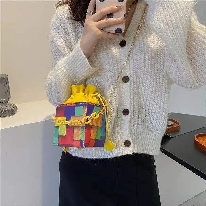 Vibrant Geometric Bucket Bag Bold Color Blocks Trendy Chain Accent Drawstring Closure Compact Statement Accessory Eye-Catching