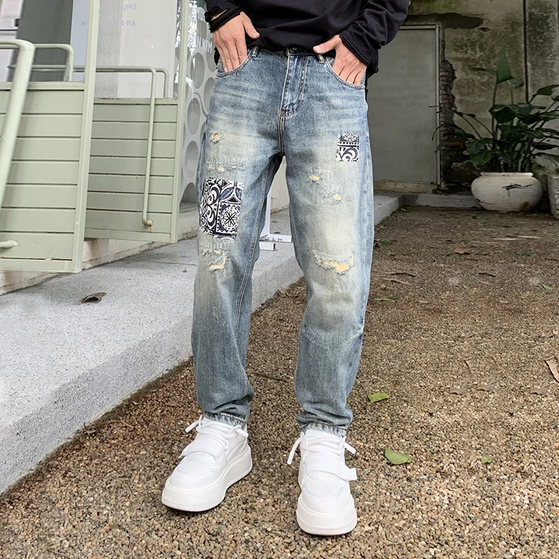 New high-end fashion tapered jeans men influx of loose pants personalized scraping hole patches Harlan pants men's pants