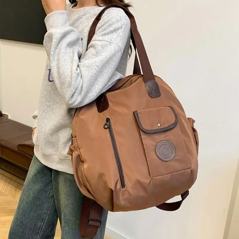 

Y3NE Functional Nylon School Bag Convertible to Shoulder or Backpack Large Capacity Handbag for Commuters and Students