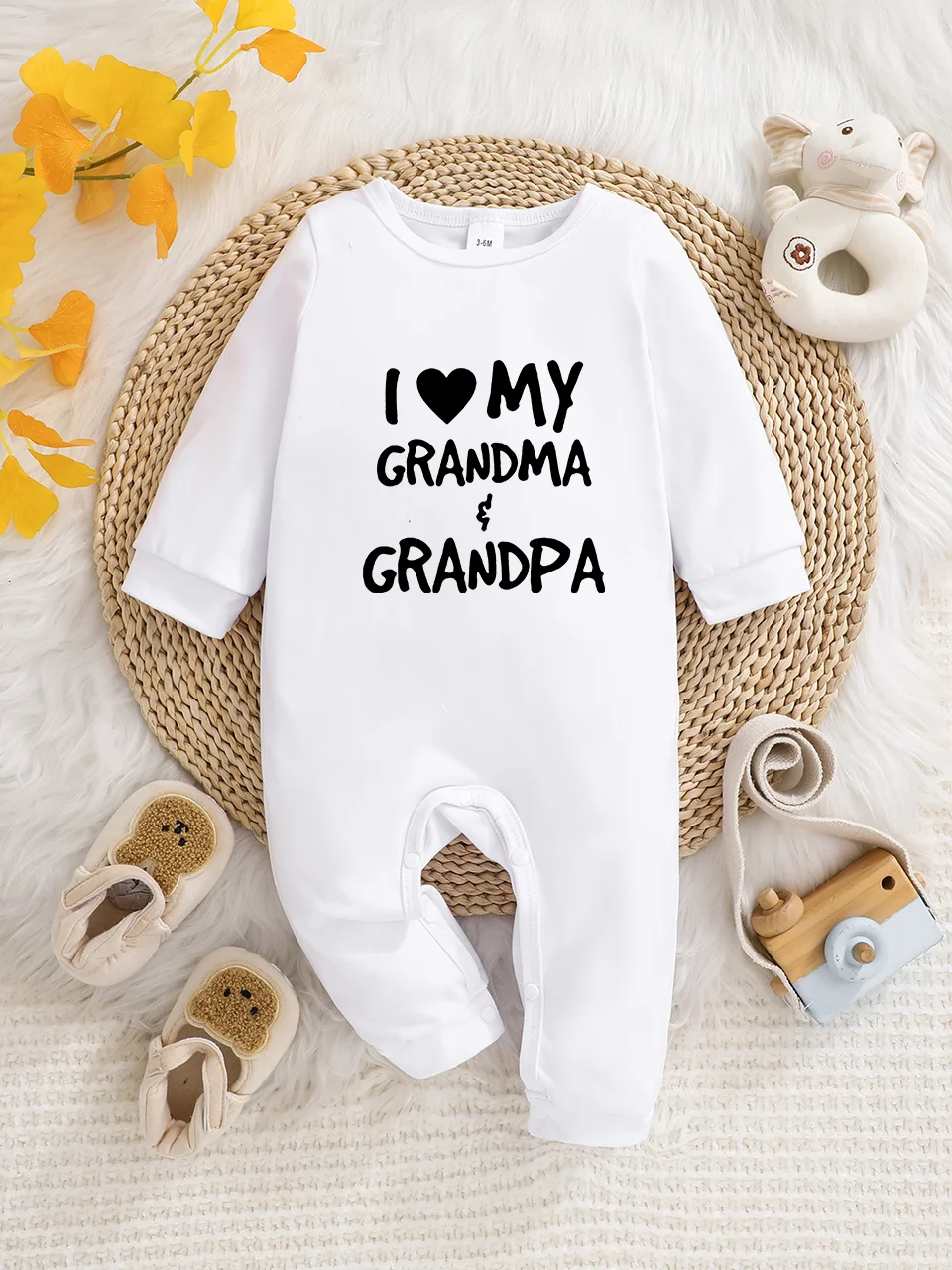 A baby long-sleeved onesie with interesting letter prints. It features a buttoned design for easy putting on and taking off