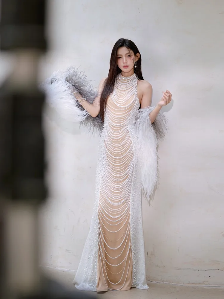 

A fashionable hand-stitched beaded and heavy-duty chain mini dress with cinched waist