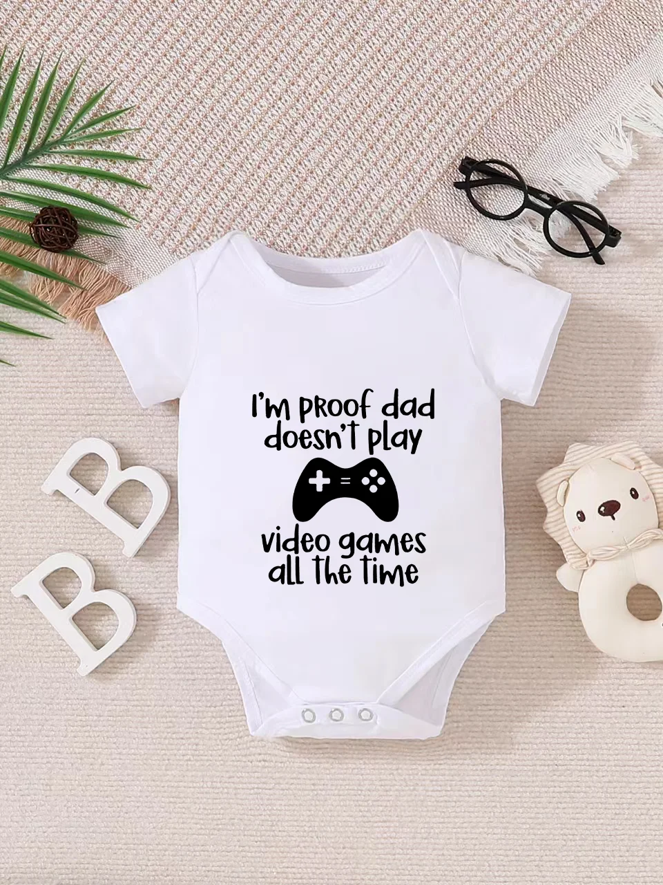 Playful letter-printed baby short-sleeve triangle bodysuit. Button closure for easy dressing, machine washable