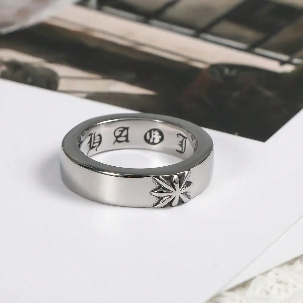 

Stainless Steel Ring with Engraved Star Motif and Interior Symbolic Pattern