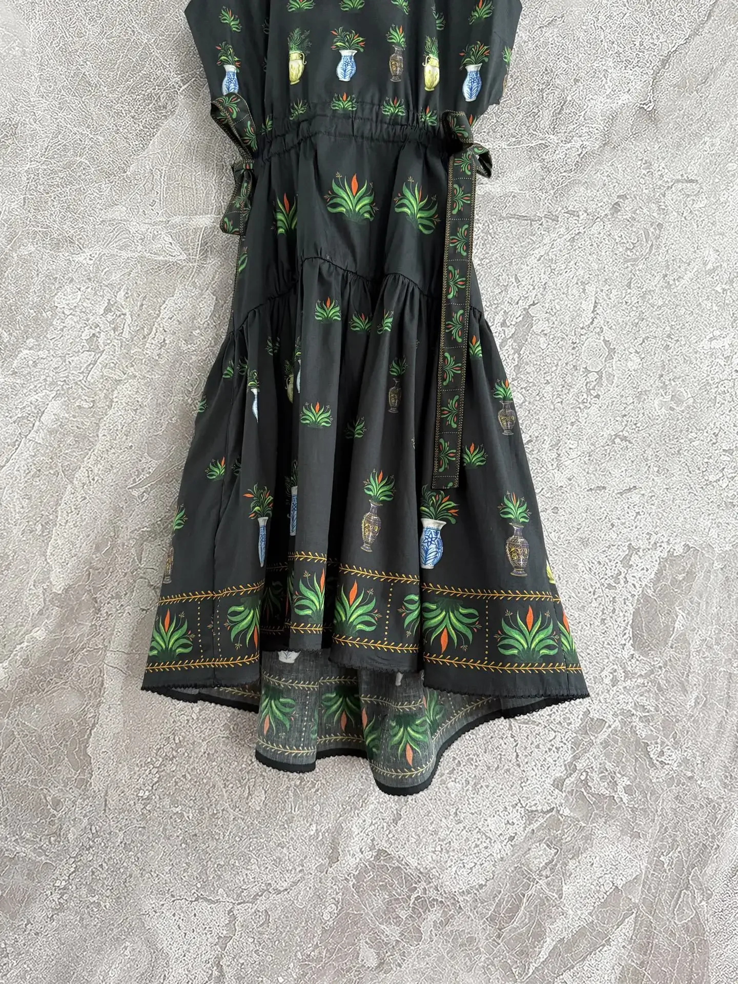 فستان قصير بخصر مقطوع على نباتات خضراء عالية الجودة بدون أكمام