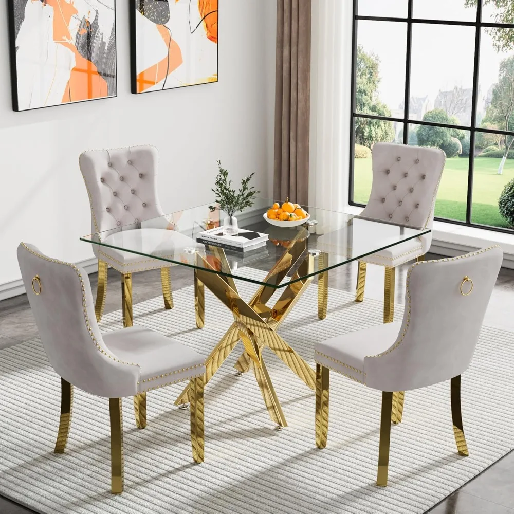 

Gold glass dining table with cross metal legs and 4 beige velvet upholstered chairs