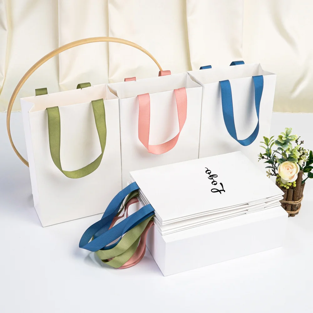 

Custom Logo High-Grade White Paper Handbag Thickened Cosmetics Perfume Shopping Tote Bag Jewelry Packaging Gift Bags with Ribbon