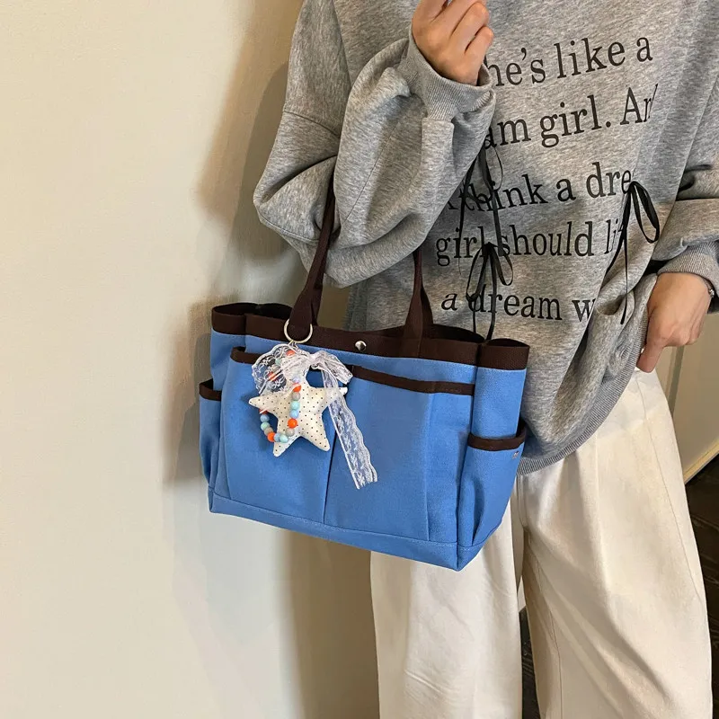 New color-blocked, multi-pocket canvas tote bag for women, large capacity, suitable for commuting and as a shoulder bag2026New v