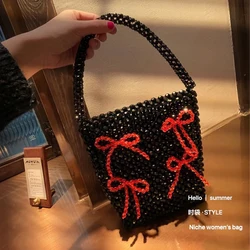 Nuova borsa a secchiello da donna in tessuto di perline con papillon in acrilico di alta qualità personalità della moda borsa da donna fatta a mano in cristallo nero