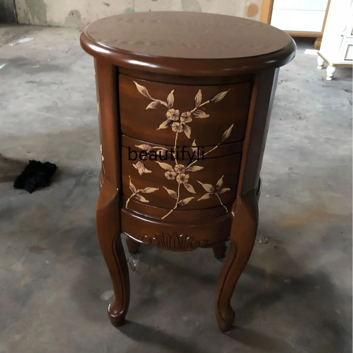 Round Table Several Piles of Gold Painted Furniture Two Chests Sofa Side Table