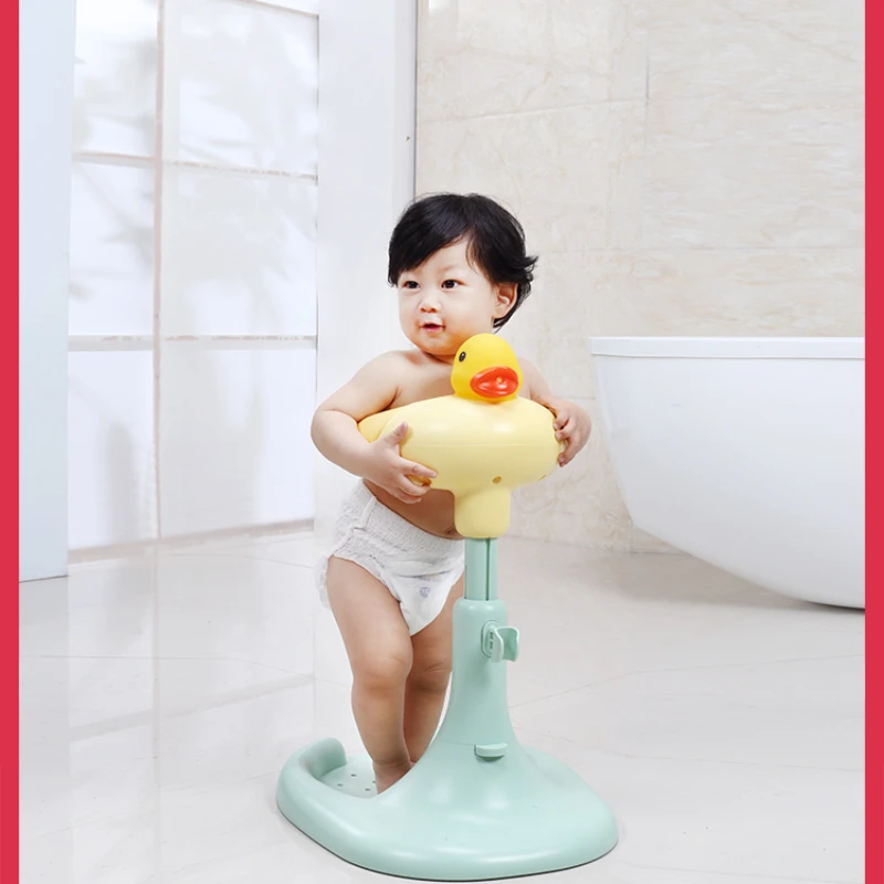 Red billed duck baby takes a bath, baby stands and washes in a basin