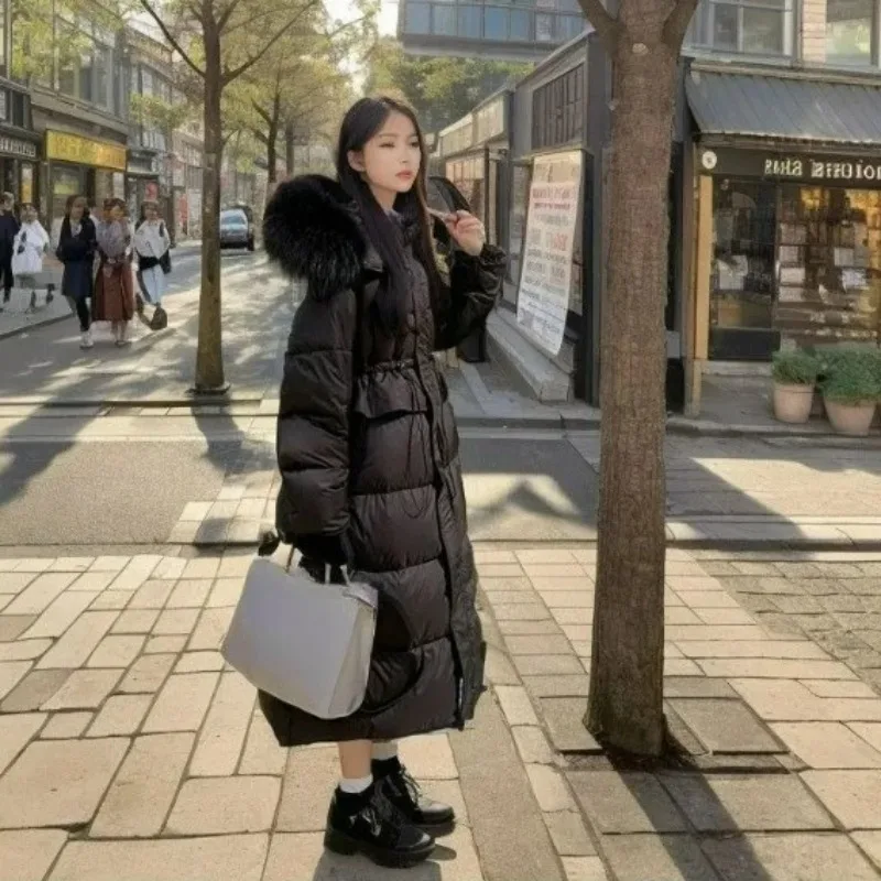 2026 سترة طويلة للنساء الشتاء مقنعين مع كبيرة الفراء طوق Cinched الخصر جديد الراقية معطف دافئ الوردي الملابس النسائية