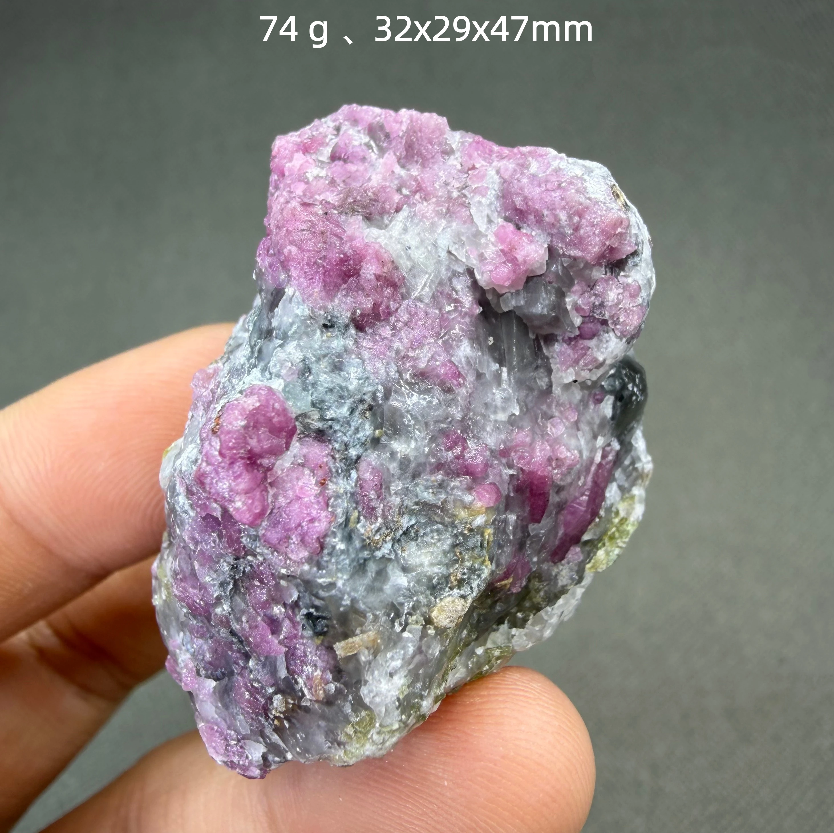 74 g Fluorescent Vietnamese ruby and green tourmaline coexist as minerals.