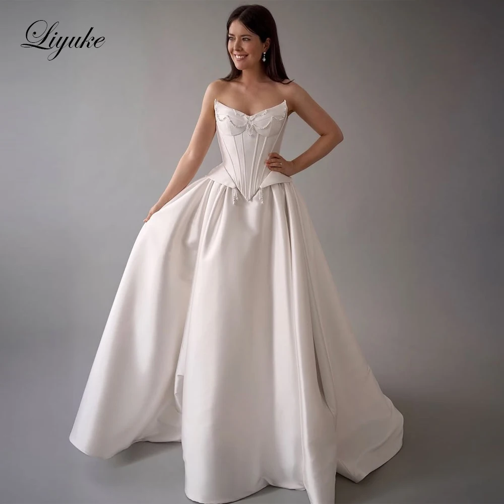 Liyuke Maßgeschneidertes A-Linie-Hochzeitskleid aus Satin mit U-Boot-Ausschnitt und Perlen, schulterfrei, ärmellose Brautkleider