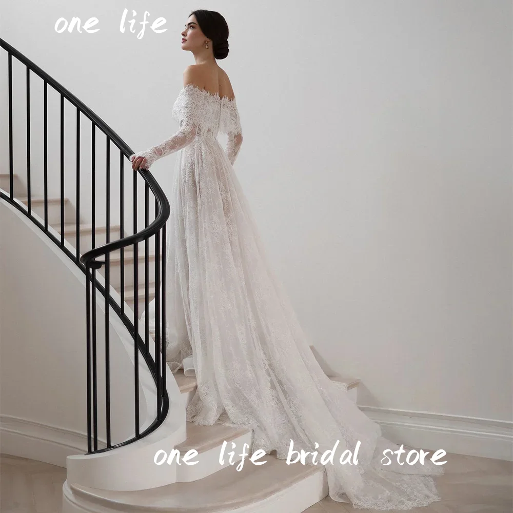 فستان زفاف دانتيل عربي رائع من OL مخصص قبالة الكتف وأكمام طويلة لؤلؤي على شكل حرف A مشد فستان زفاف عربي