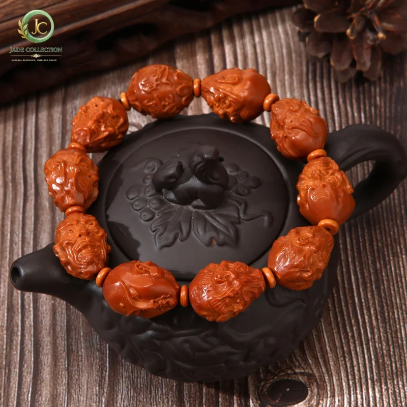 Hand-carved olive pit bracelet featuring the Eighteen Arhats and the God of Wealth, a handcrafted art piece for men and women to