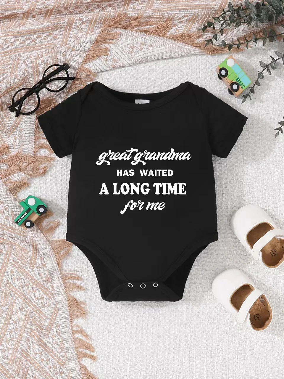 Playful letter-printed baby short-sleeve triangle bodysuit. Button closure for easy dressing