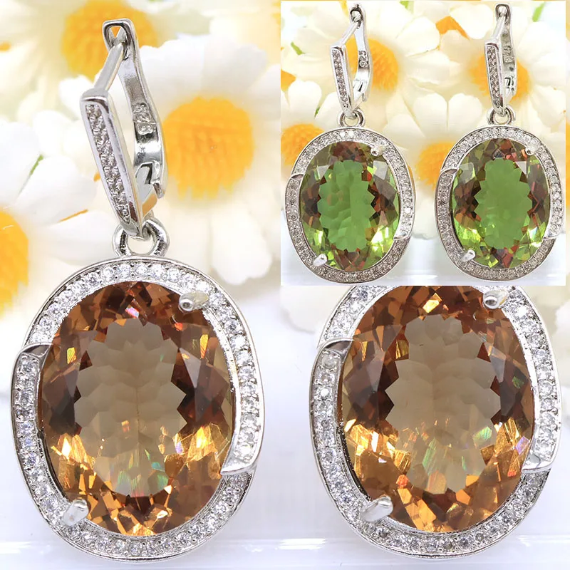 

Серьги-подвески 40x20 мм с крупными искусственными камнями: селтана, меняющего цвет александрита, зеленого топаза и изумруда, с серебряным покрытием