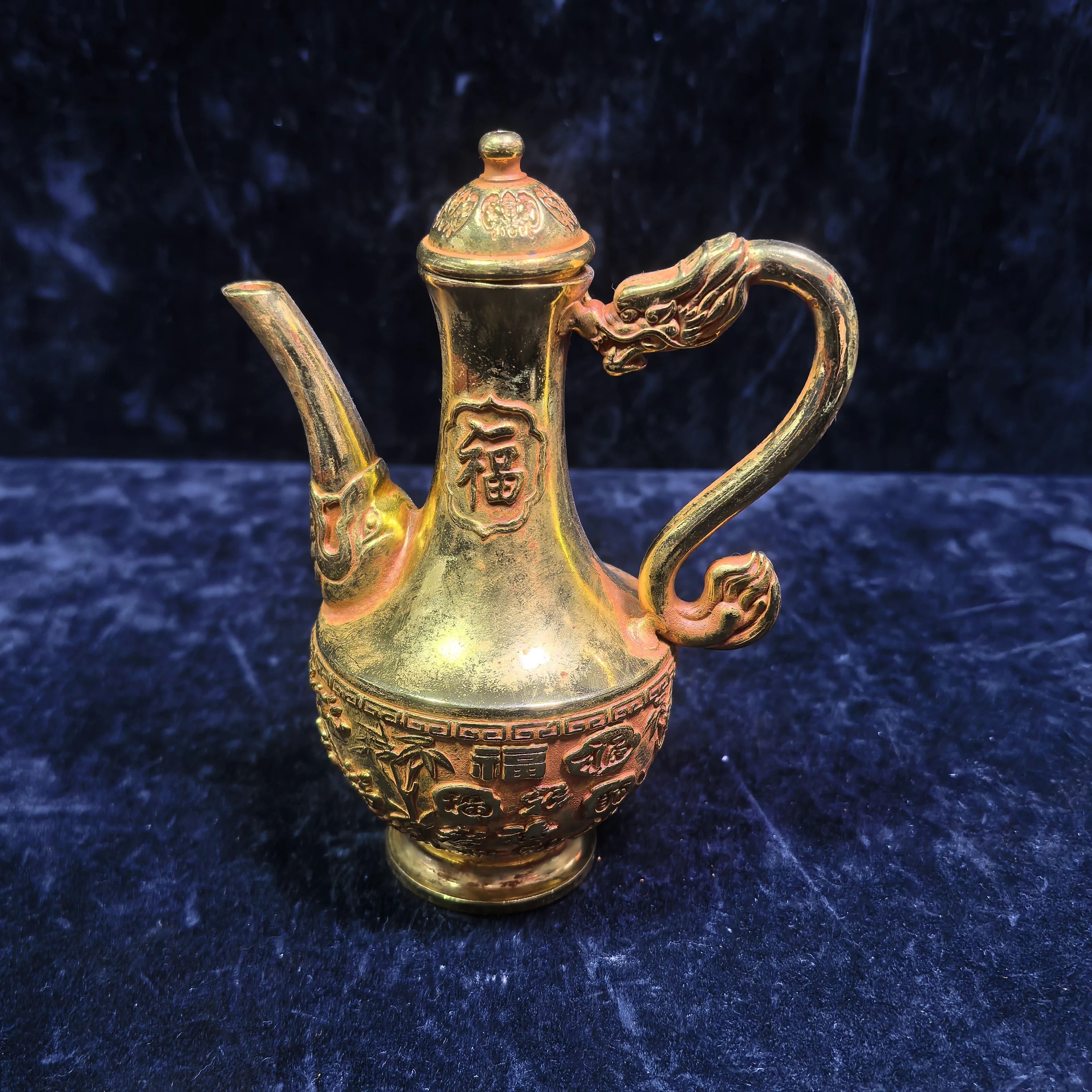 

A gilded copper-carved "Fu" character dragon head and wine pot for home decoration